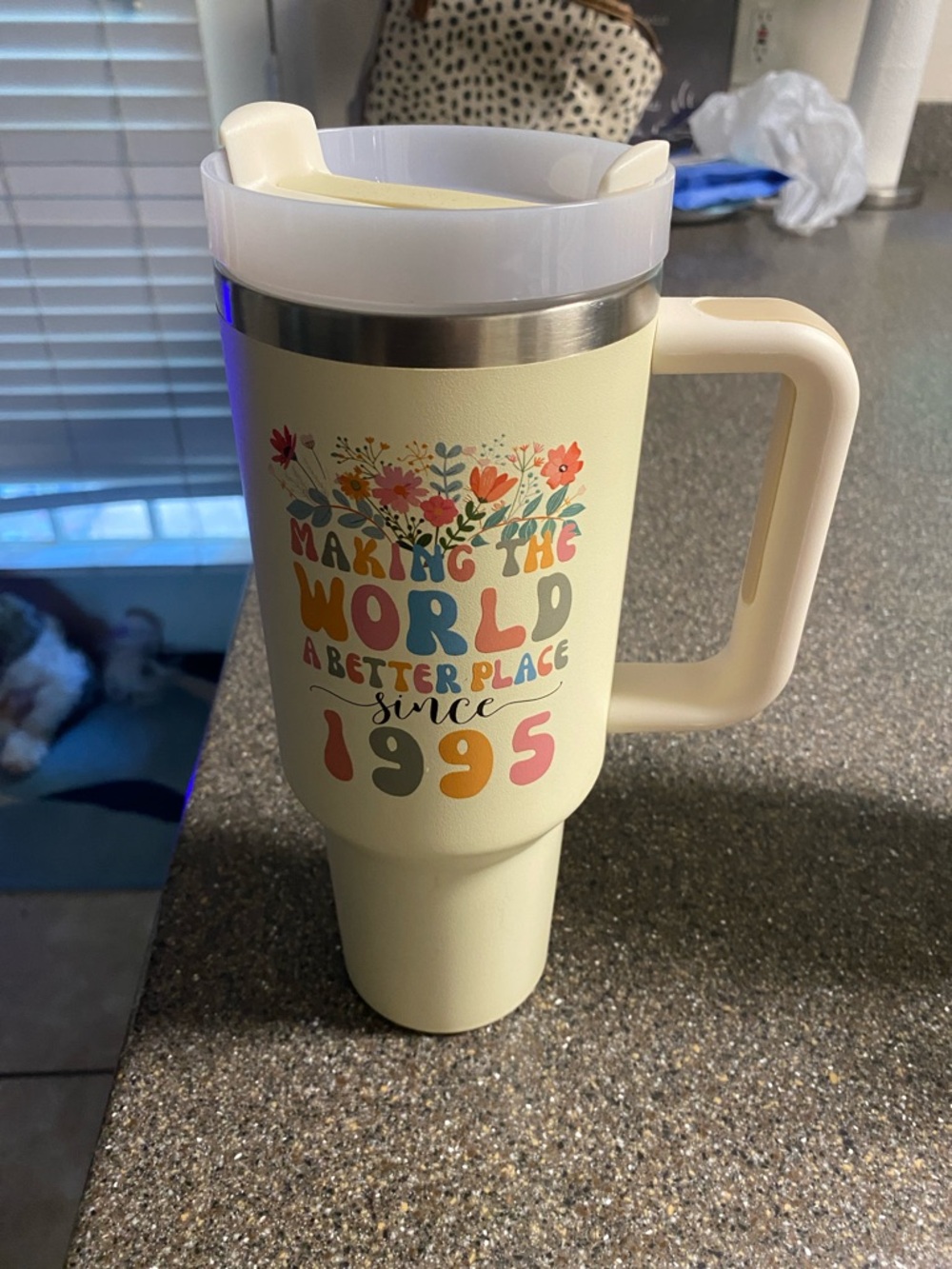 Cream Travel Mug with Floral "Making the World a Better Place" Graphic